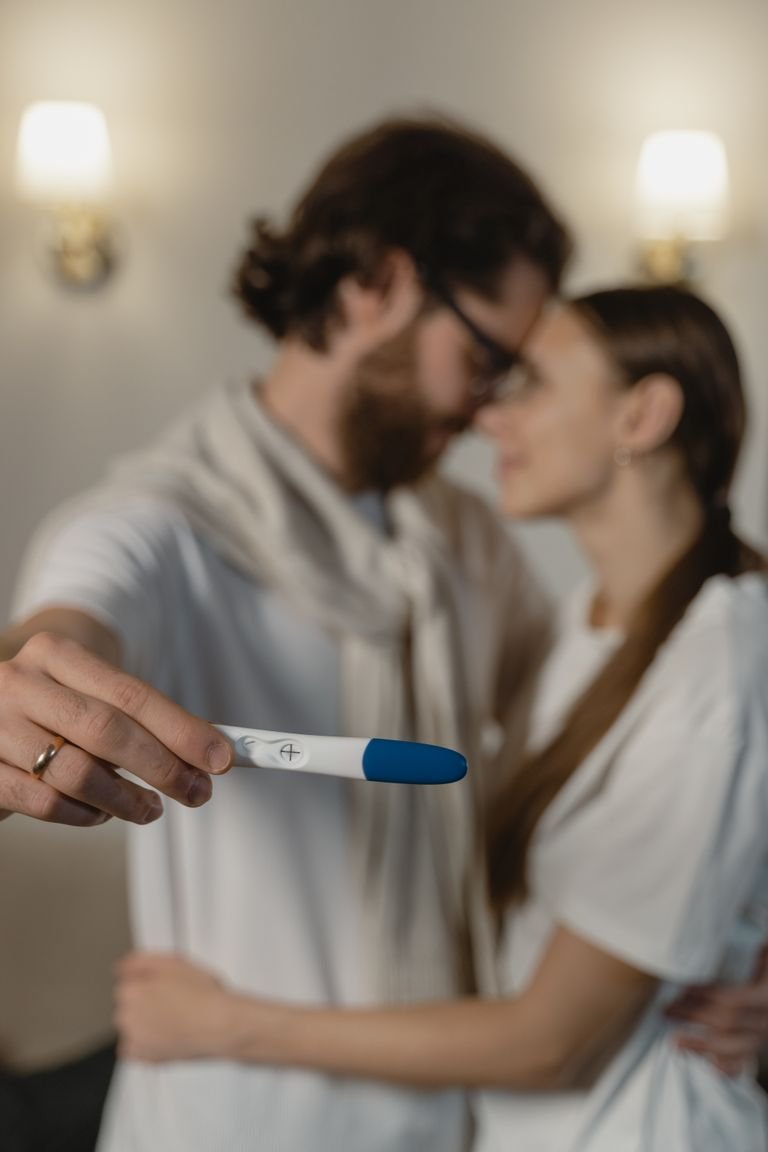 A loving couple rejoicing in a positive pregnancy test result, symbolizing new beginnings.